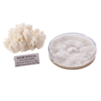 A white coral-shaped honeycomb mushroom culture sample next to a clear petri dish showing a white mycelial mat, with a label reading 'AGGietROPICAL CULTURE BANK'.