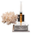 A coral tooth liquid mycelium kit by Aggietropicals, featuring a clear acrylic syringe filled with amber liquid, a clear acrylic base with a silver metal plaque, and a white coral tooth prop, all on a white background.