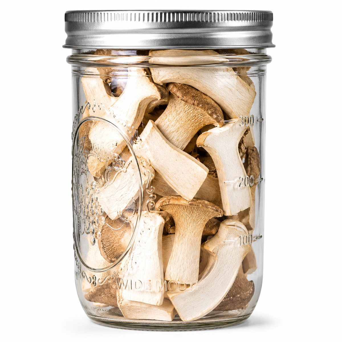A clear glass mason jar with a silver metal lid, filled with sliced dried mushrooms, shown against a plain white background.