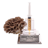 A 10g liquid mycelium spawn kit by Aggietropicals Maitake, featuring a Maitake mushroom, a clear plastic syringe filled with golden-brown liquid, and a clear acrylic stand with a silver metal base.