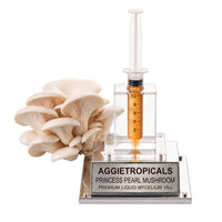 A dense cluster of Princess Pearl mushrooms with creamy white ruffled caps, beside a syringe filled with liquid mycelium culture mounted on a mirrored stand, labeled "AGGIETROPICALS, PRINCESS PEARL, PREMIUM LIQUID MYCELIUM 10cc", on a white background.