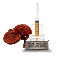An AGGietropicals Reishi Mushroom premium liquid mycelium 10cc syringe product on a clear acrylic stand with a silver metal plaque, shown alongside dried reishi mushrooms on a white background.
